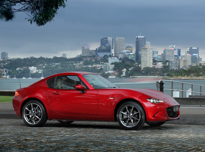 Red 2017 Mazda MX-5 RF GT parked by a city waterfront