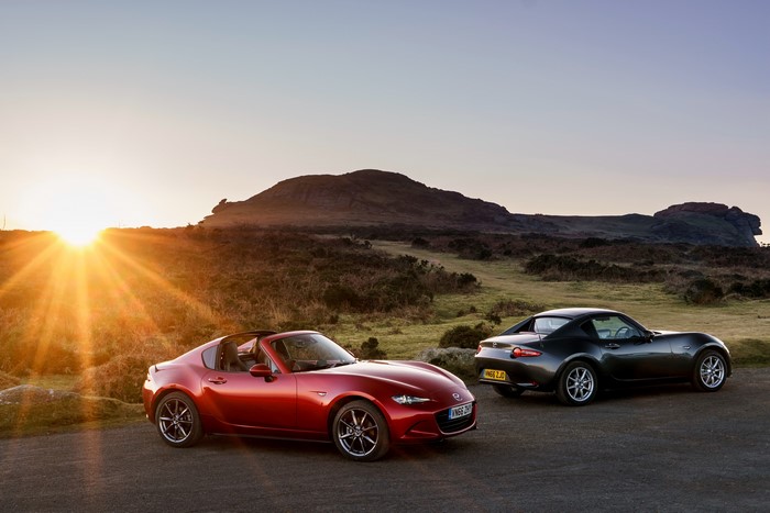 Two Mazda MX-5 RF cars at sunset