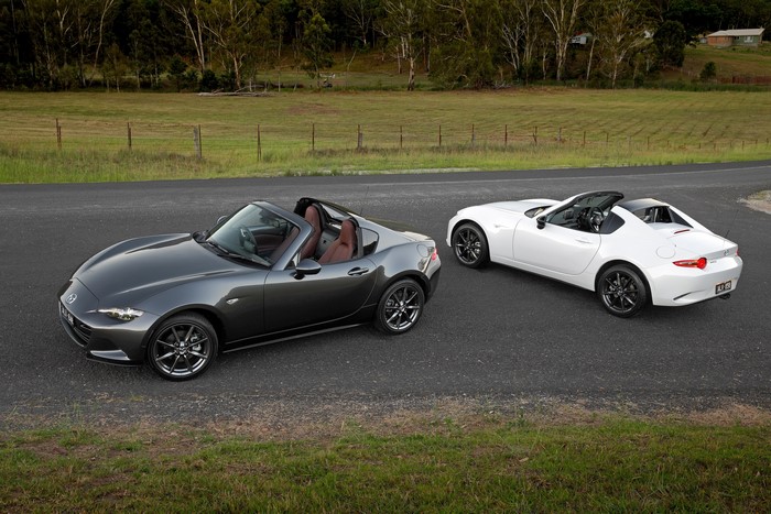 Two Mazda MX-5 RF convertibles on a road
