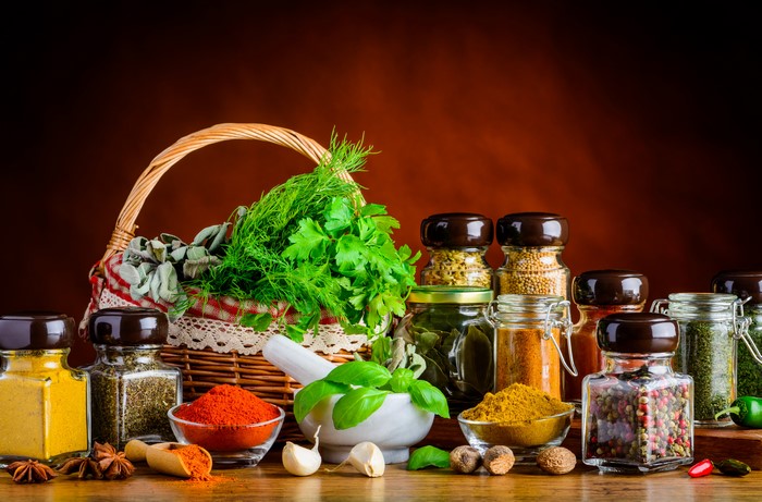 Still-life of spices and herbs in a wicker basket