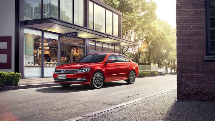 Red 2015-17 Volkswagen Lavida parked outside coffee shop