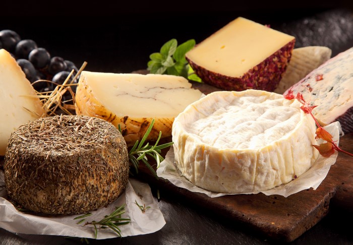 Assortment of cheeses with grapes and herbs