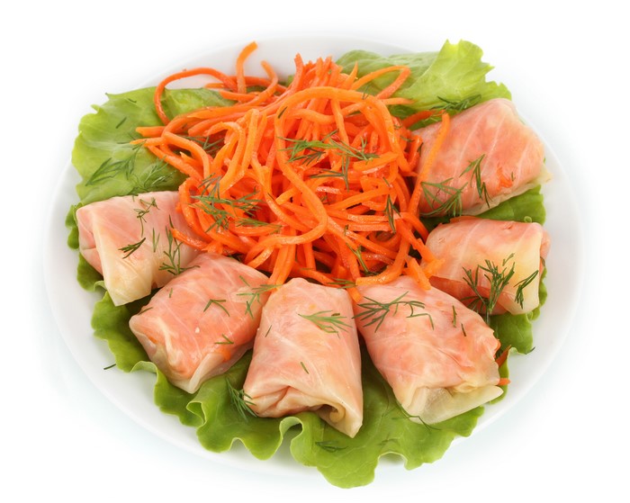 Stuffed cabbage rolls with shredded carrots and lettuce