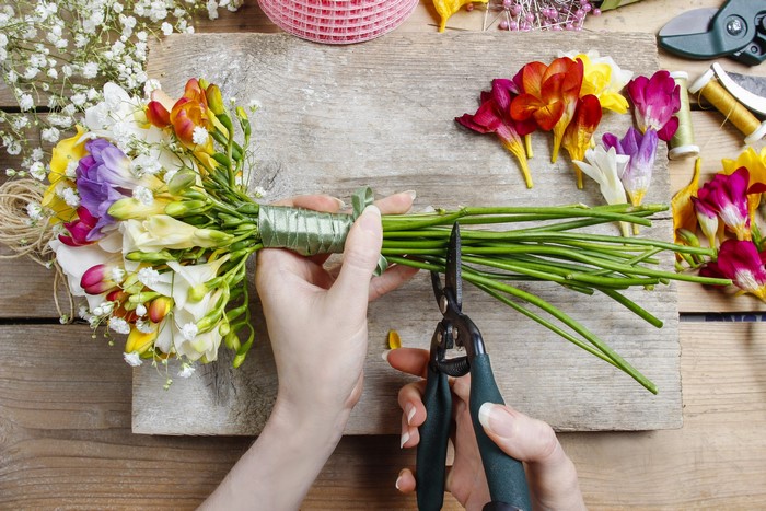 Florist arranging a bouquet with scissors