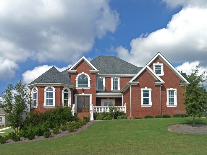Red brick mansion with arched windows and dormers