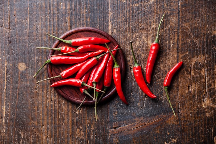 Red chili peppers on a wooden table