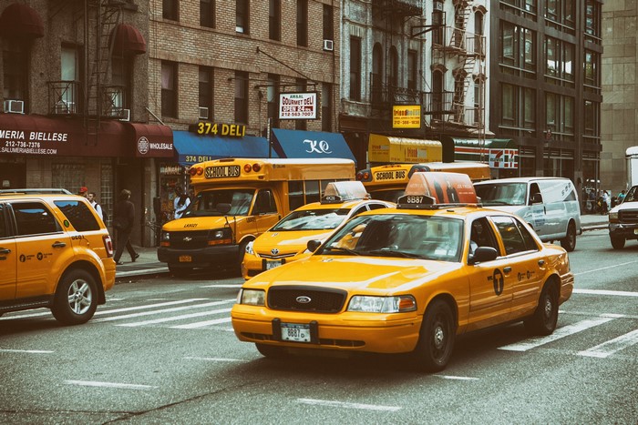 Yellow Taxis and School Buses on a New York City Street