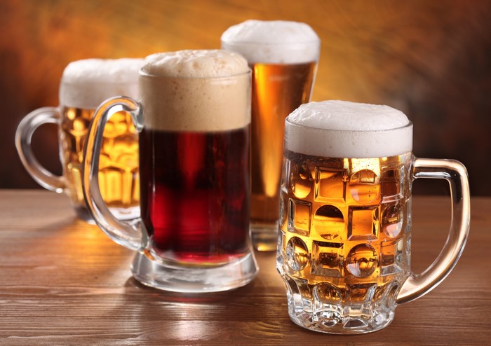 Four mugs of beer with foam