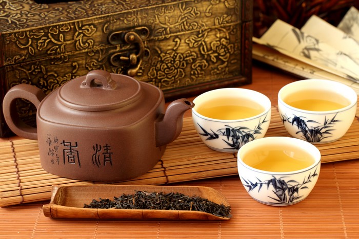 Tea set with teapot, cups, and tea leaves