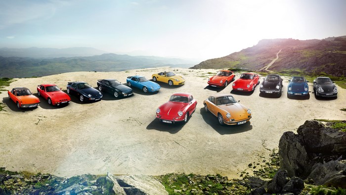 Collection of vintage Porsche cars on a mountain road