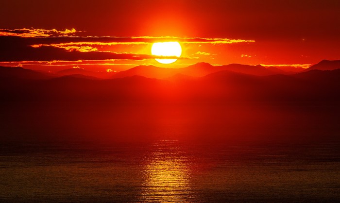 Sunset over mountains and ocean