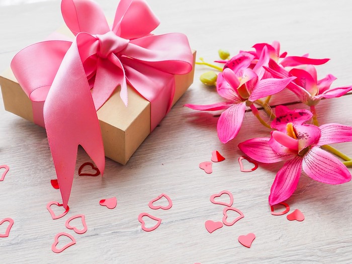 Gift box with pink bow and orchids
