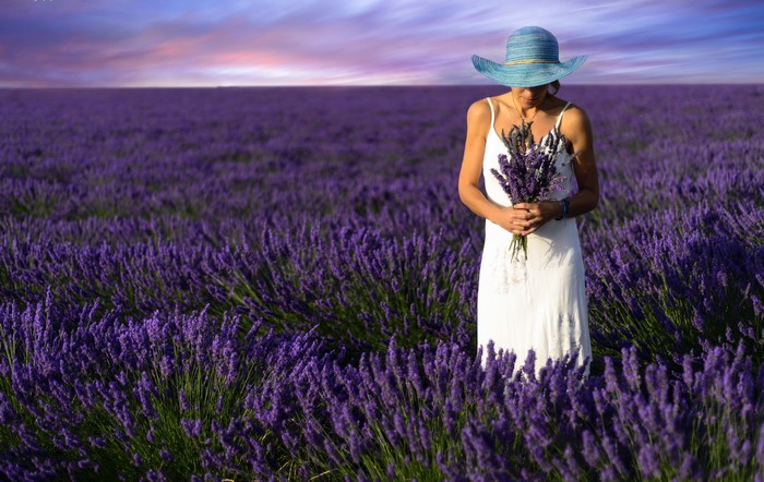 Woman in a blue hat in a lavender field