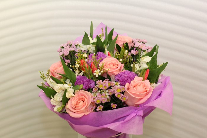 Bouquet of pink roses and purple flowers