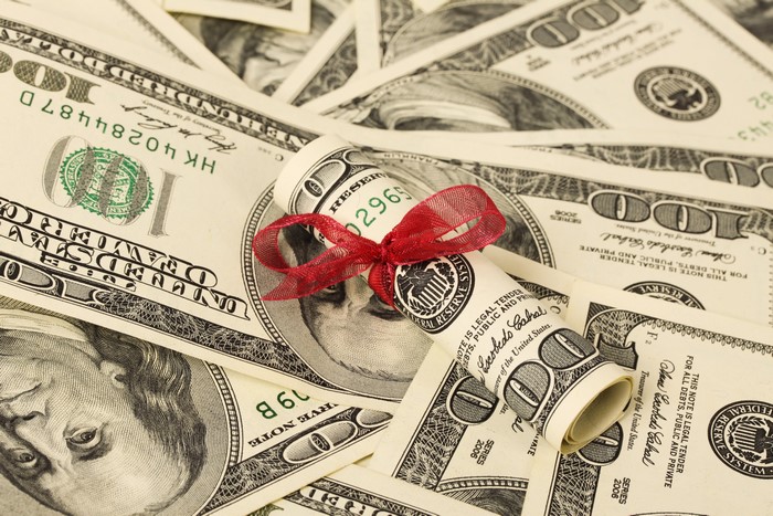 Rolled US Dollar Bills Tied with Red Bow