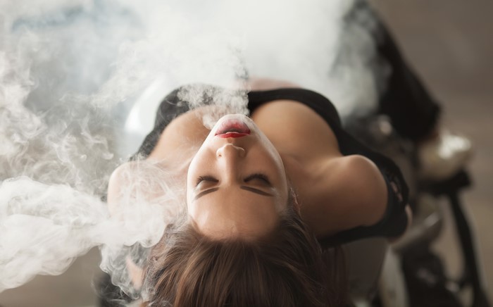 Woman exhaling smoke