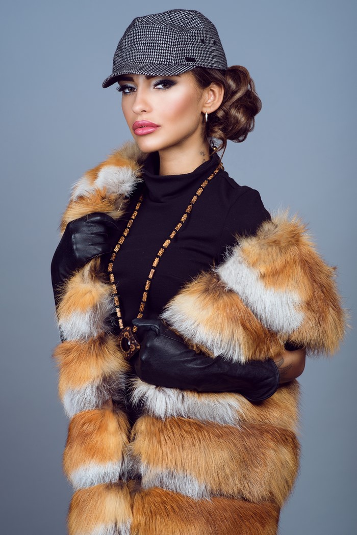 Woman in fur coat and cap with jewelry