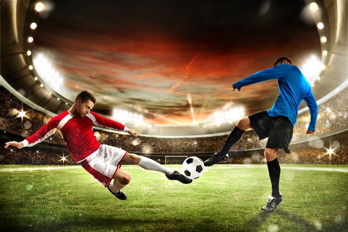 Two men playing soccer in a stadium