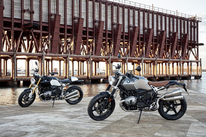 Two BMW R nine T motorcycles by a pier
