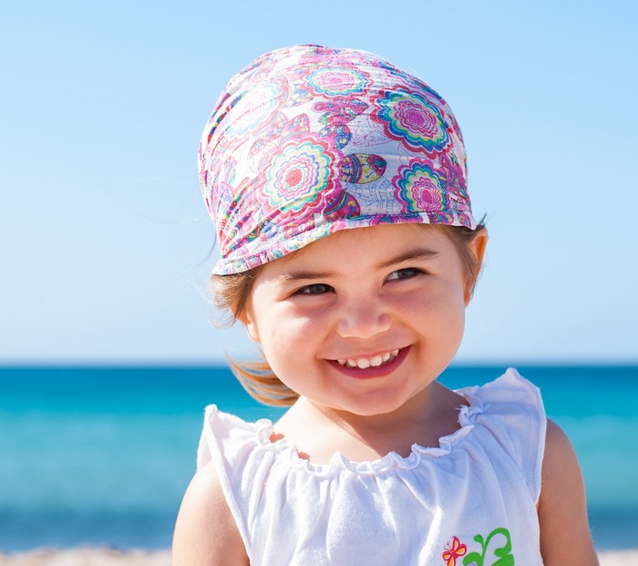 Young girl wearing a bandana on the beach
