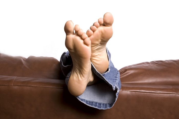 Feet resting on a leather couch