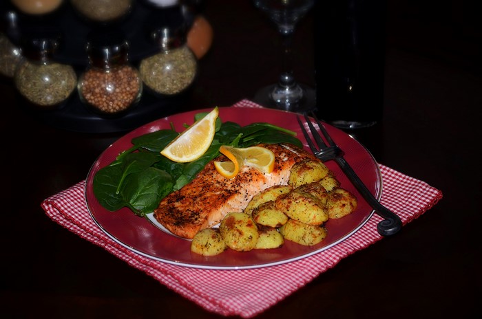 Salmon with potatoes and spinach on a plate