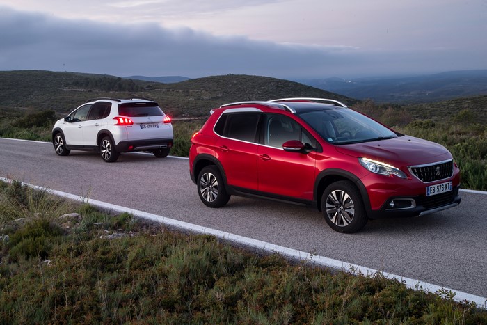 Two Peugeot 2008 cars on a road