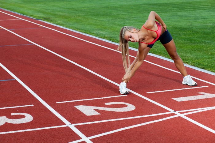 Woman stretching on a running track