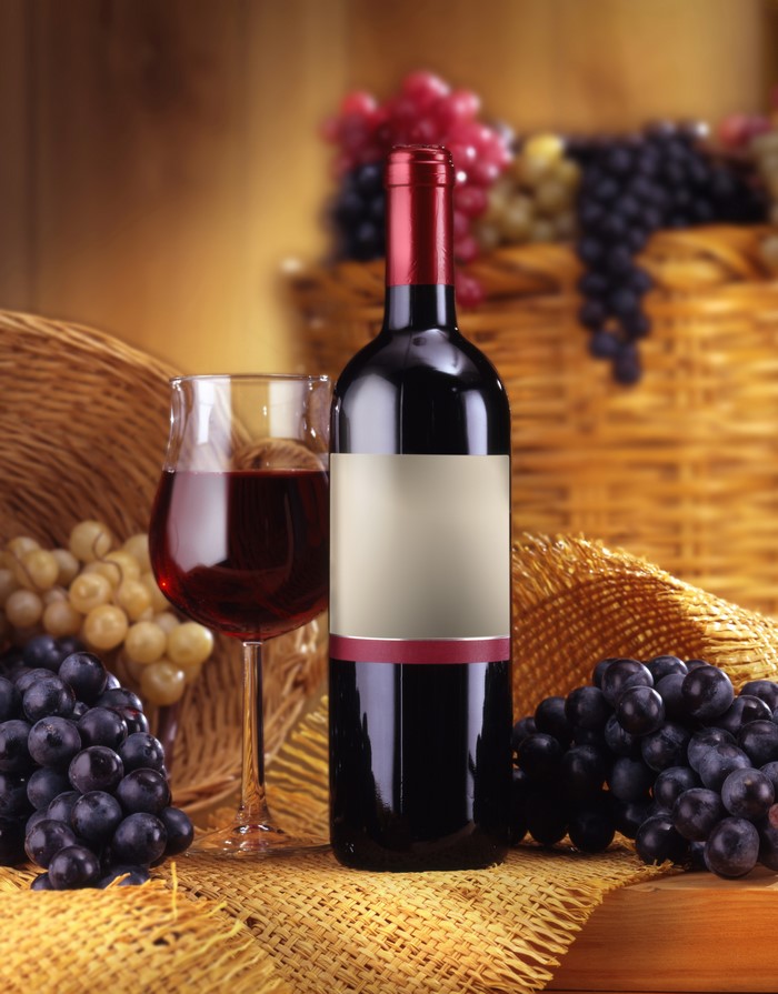 Wine bottle and glass with grapes