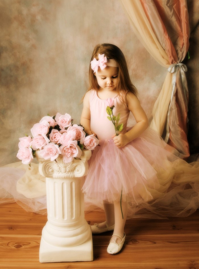 Little girl in pink dress with roses
