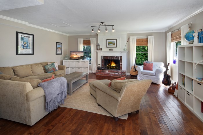 Living room with sofa, armchair, and fireplace