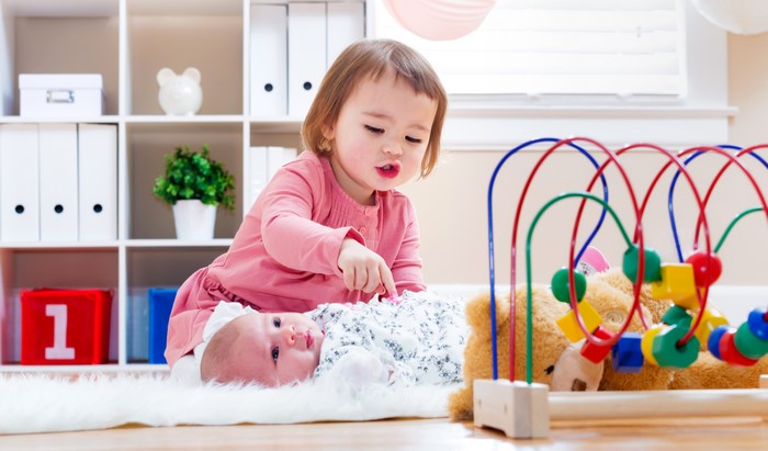 Two young girls playing with toys