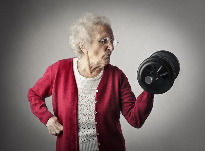 Old woman lifting a dumbbell