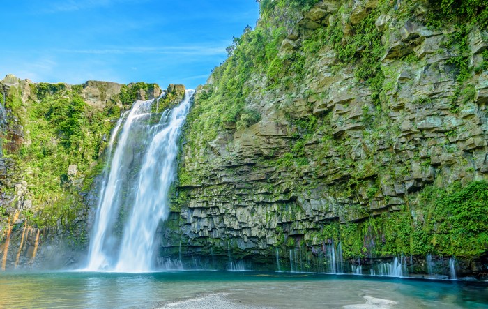 4K Waterfall cascading down a rocky cliff
