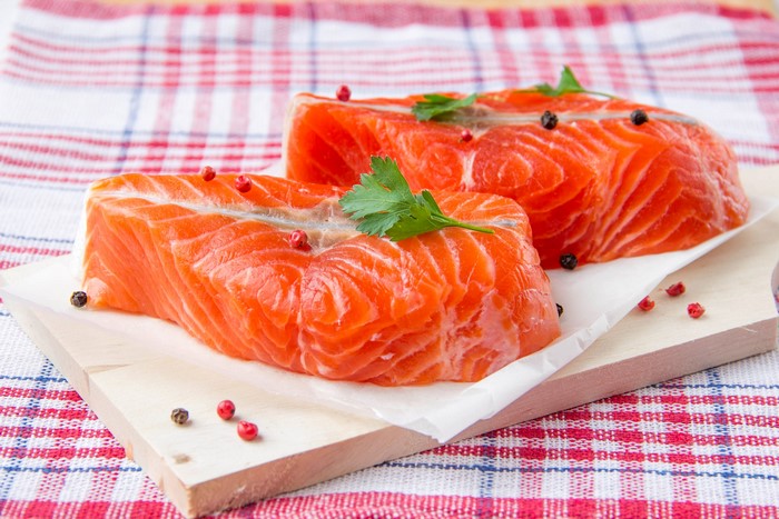 Raw Salmon Fillets on Cutting Board