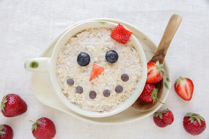 Oatmeal snowman with strawberries and blueberries