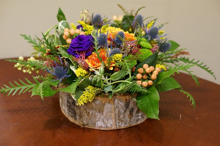 Floral arrangement in a birch log container