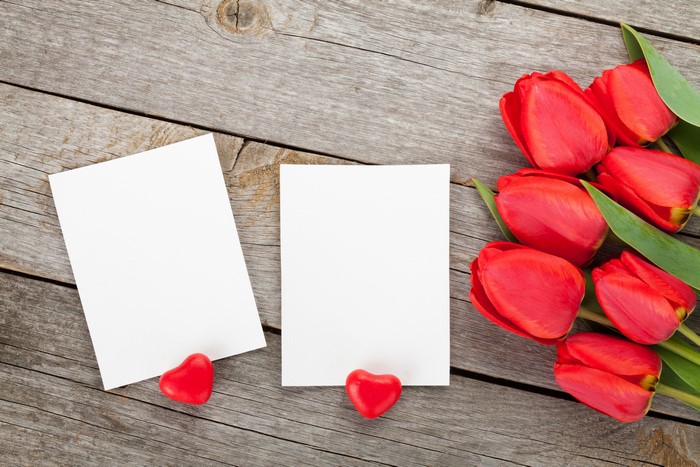 Red Tulips and Heart Shaped Candies on Wood