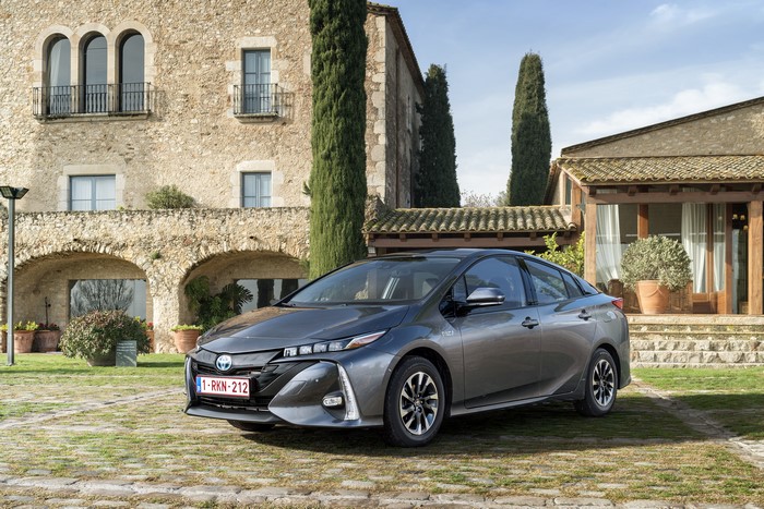Grey Toyota Prius Plug-in Hybrid parked in front of a stone building