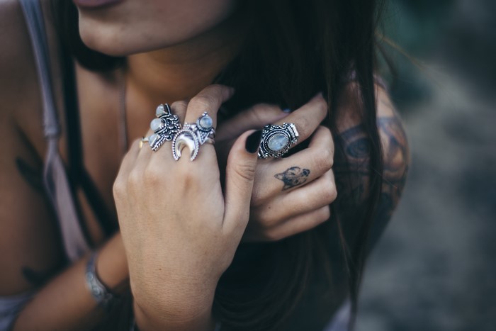 Woman wearing rings and tattoos