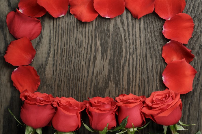 Red Roses and Petals on Wood Planks
