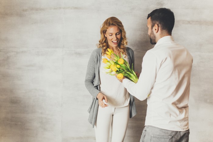 Man giving tulips to a smiling woman