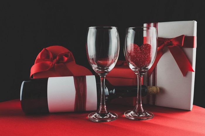 Wine glasses with gifts and wine bottle