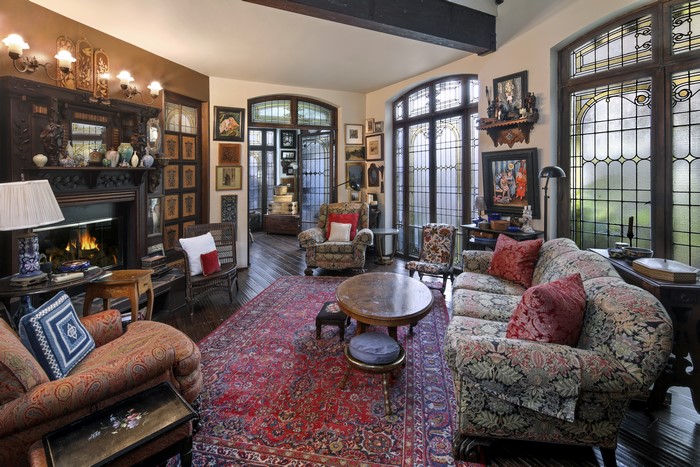 Living room with fireplace, sofa, and armchair