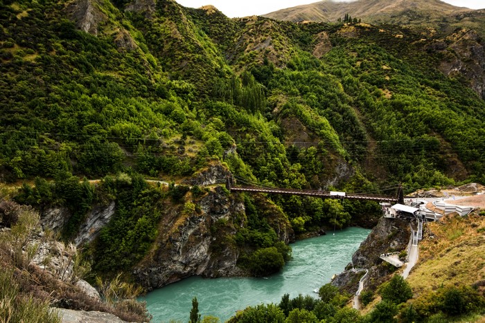 Bridge over turquoise river in Queenstown, New Zealand