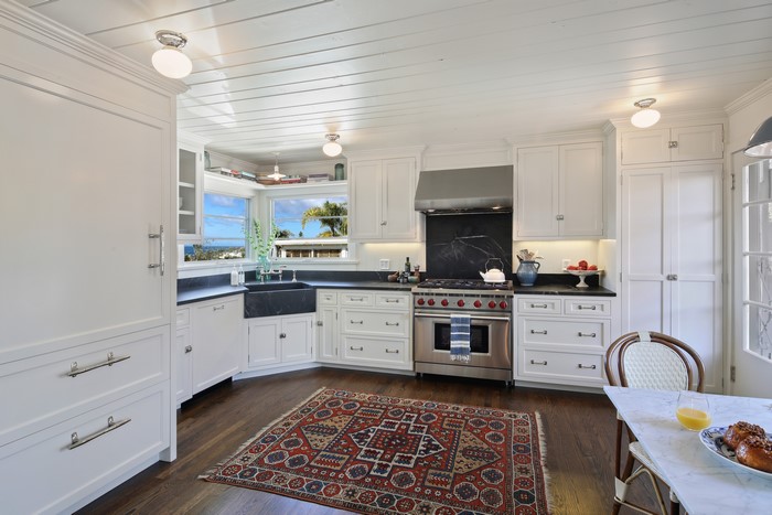 Kitchen with White Cabinets and Rug