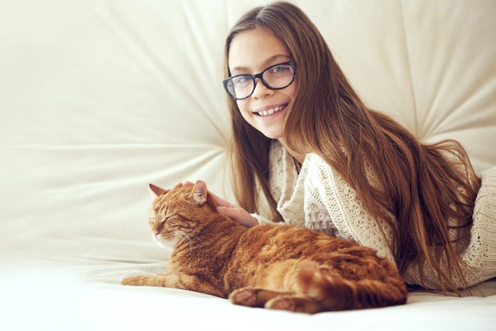 Girl with Glasses and Orange Cat