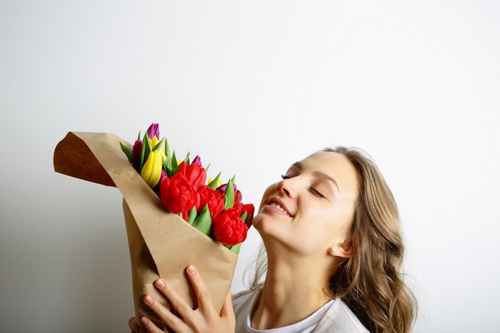 Woman smelling a bouquet of tulips