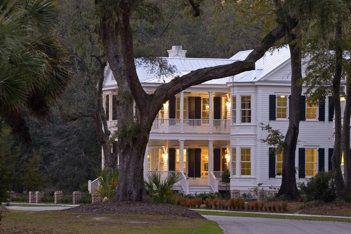 White Southern Mansion with Double Porches and Large Trees