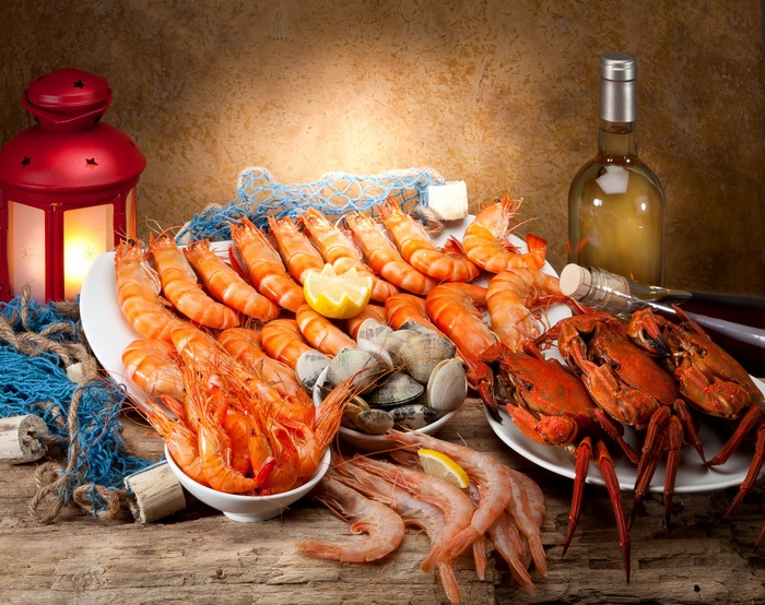 Seafood platter with shrimp, crabs, clams, and wine